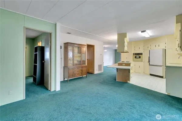 a kitchen with stainless steel appliances kitchen island sink refrigerator and stove