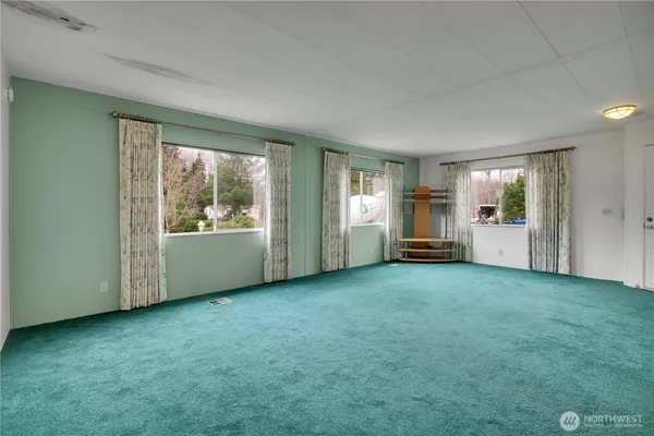 an empty room with windows and closet