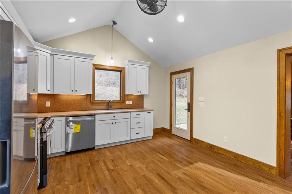 2 Quarry Road Sewickley, PA 15143 - Photo 15 of 29 a kitchen with stainless steel appliances granite countertop a sink a stove cabinets and wooden floor
