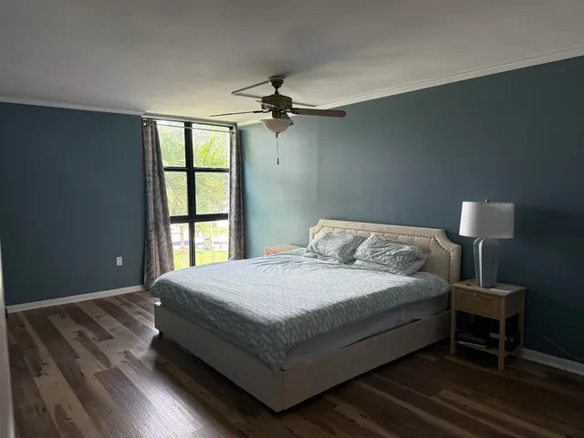 a bedroom with a bed lamp and a window