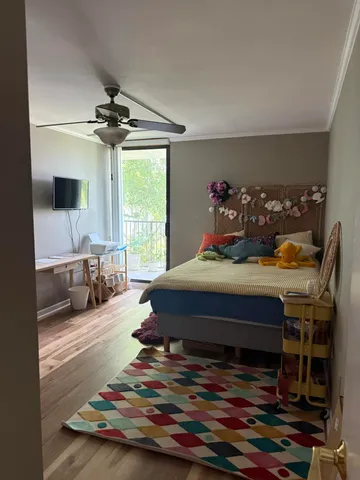 a bedroom with a bed and a large window