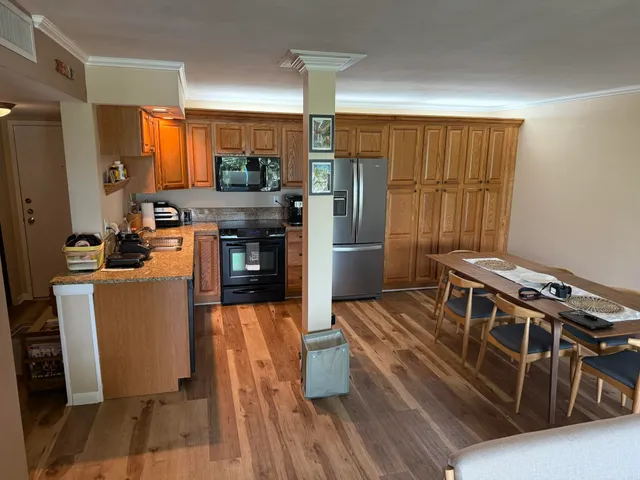 a kitchen with sink refrigerator and stove