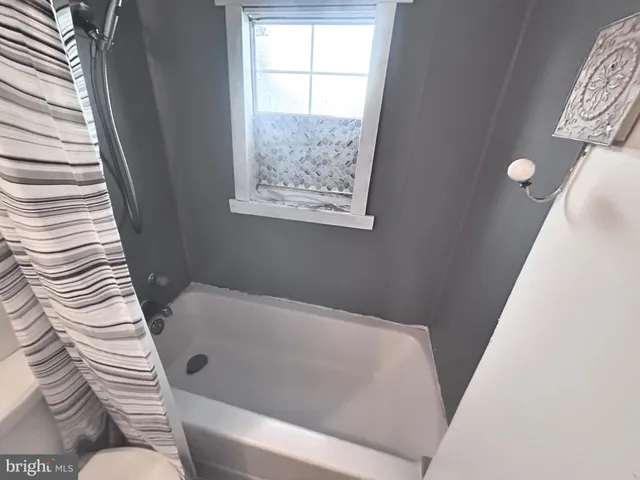 a bathroom with a bathtub and window