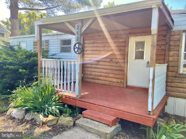 a view of a wooden bench in the back yard