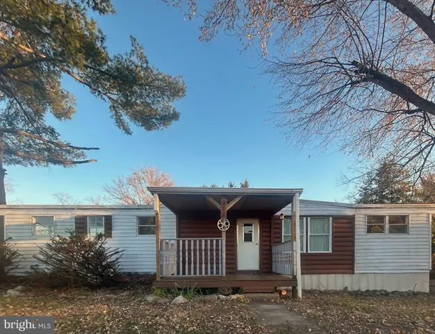 a view of a house with a yard and roof