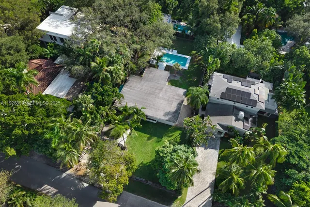 a backyard of a house with lots of green space and a lake view