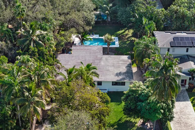 an aerial view of a house with a yard and garden