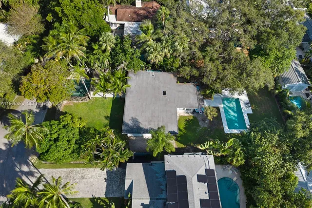 an aerial view of a house with a yard and garden