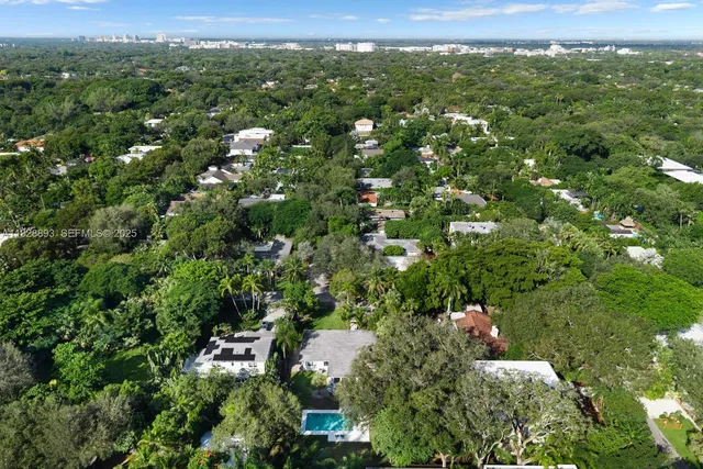 an aerial view of a houses with a yard