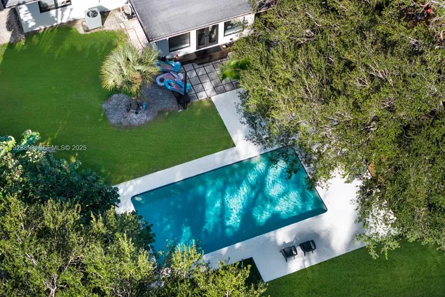 an aerial view of a house with a yard and garden