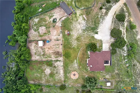 an aerial view of a house with yard