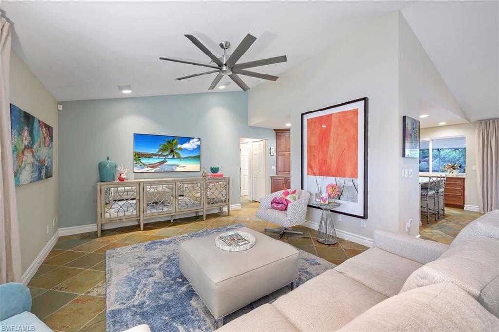 2113 Imperial Golf Course Boulevard Naples, FL 34110 - Photo 11 of 42 a living room with furniture and a flat screen tv