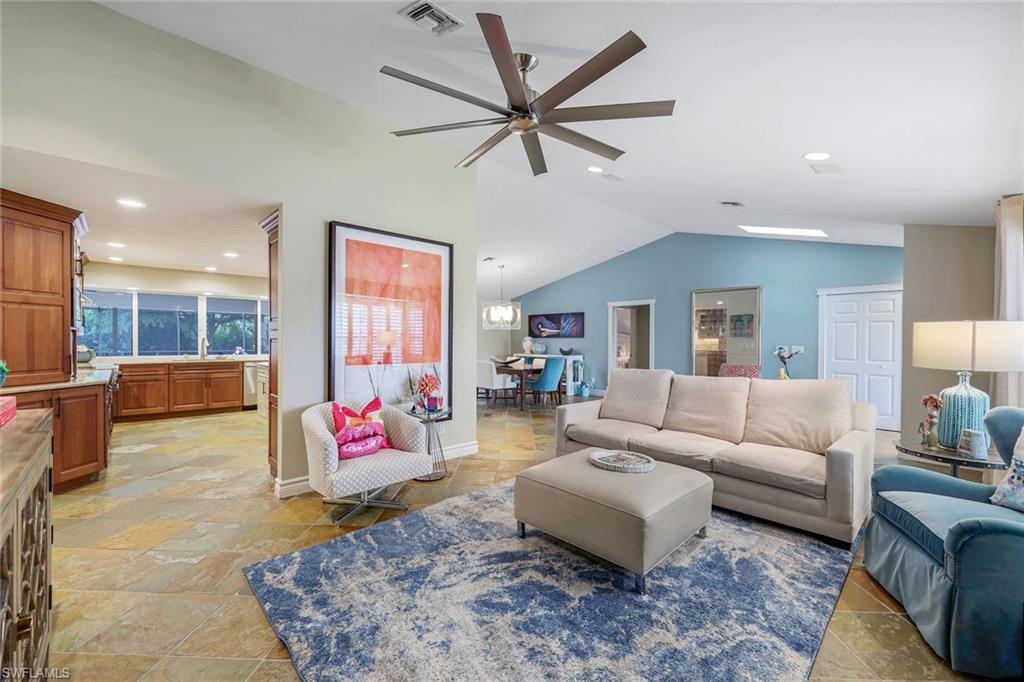 2113 Imperial Golf Course Boulevard Naples, FL 34110 - Photo 12 of 42 a living room with furniture and kitchen view