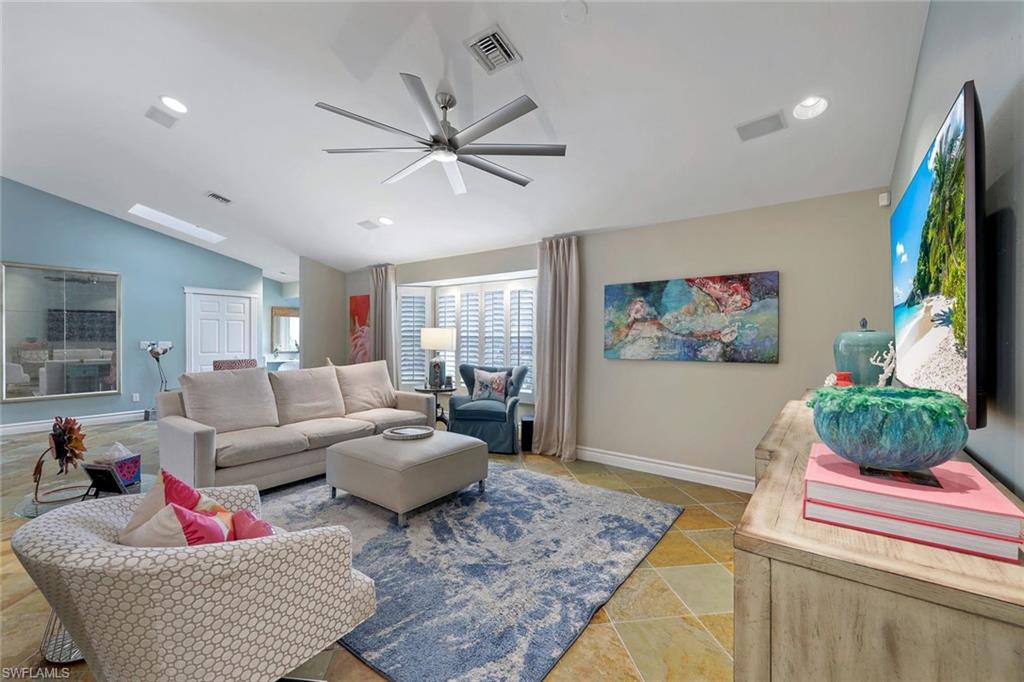 2113 Imperial Golf Course Boulevard Naples, FL 34110 - Photo 13 of 42 a living room with furniture and a flat screen tv