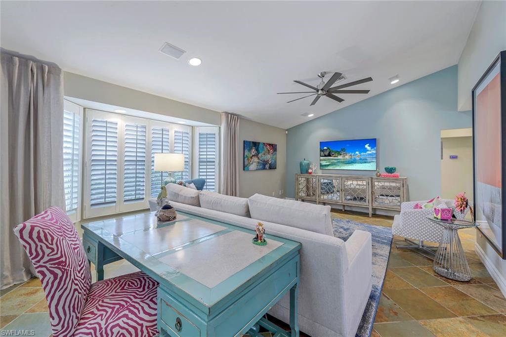 2113 Imperial Golf Course Boulevard Naples, FL 34110 - Photo 14 of 42 a living room with furniture and a flat screen tv