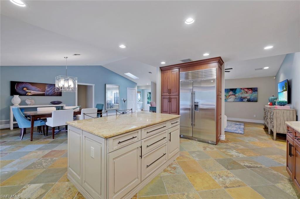 2113 Imperial Golf Course Boulevard Naples, FL 34110 - Photo 20 of 42 a large white kitchen with a large counter top and refrigerator