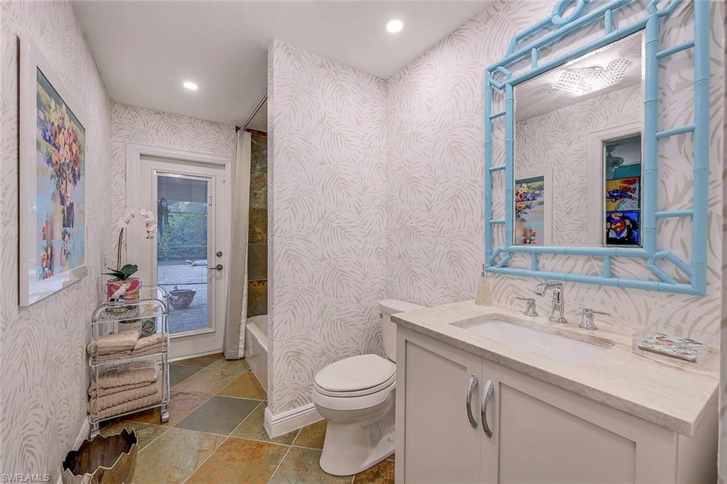 2113 Imperial Golf Course Boulevard Naples, FL 34110 - Photo 29 of 42 a bathroom with a sink vanity mirror and toilet