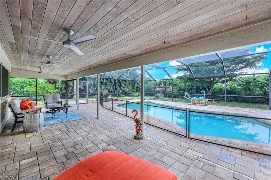 2113 Imperial Golf Course Boulevard Naples, FL 34110 - Photo 3 of 42 a view of a swimming pool with a patio