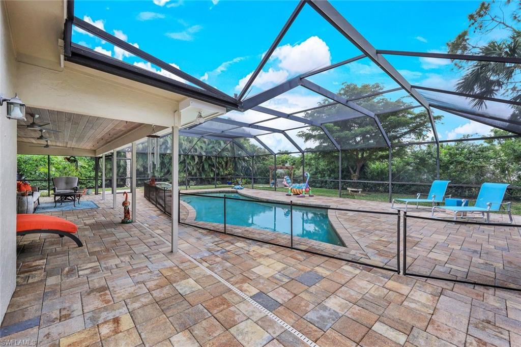 2113 Imperial Golf Course Boulevard Naples, FL 34110 - Photo 33 of 42 a view of a backyard with sitting area