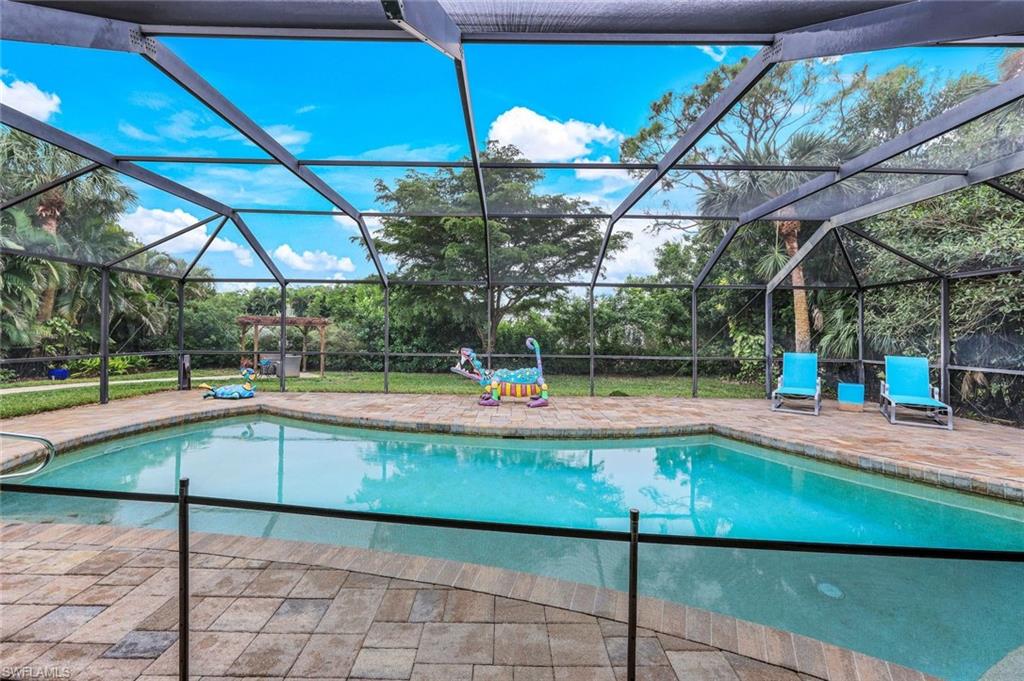 2113 Imperial Golf Course Boulevard Naples, FL 34110 - Photo 35 of 42 a view of a swimming pool with a patio