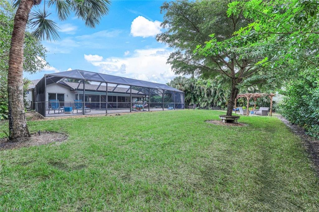 2113 Imperial Golf Course Boulevard Naples, FL 34110 - Photo 37 of 42 a view of a house with a yard
