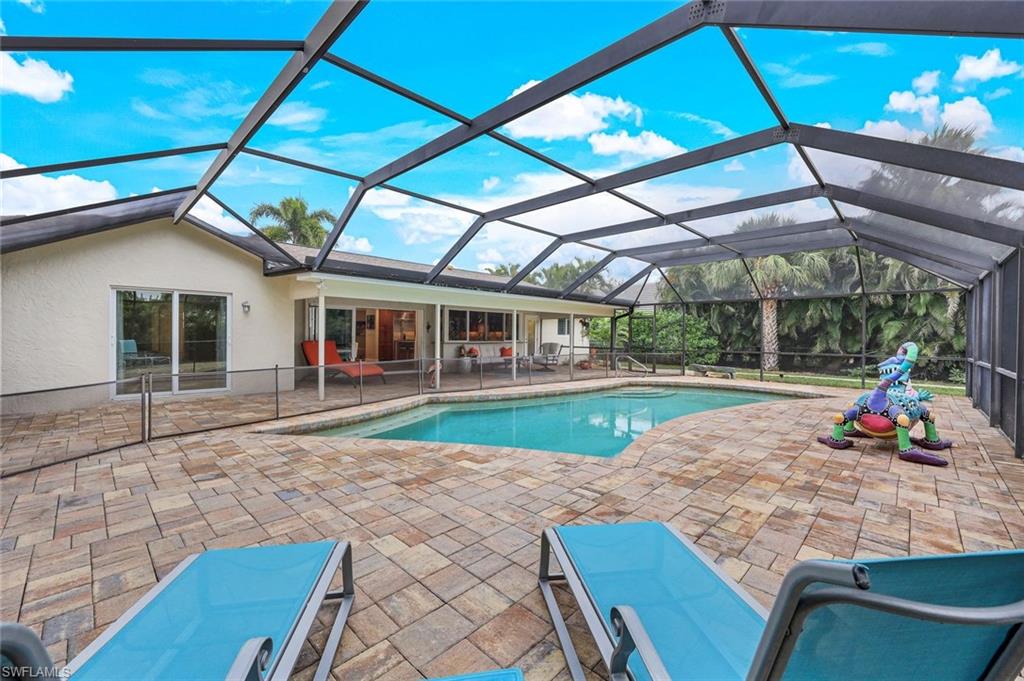 2113 Imperial Golf Course Boulevard Naples, FL 34110 - Photo 4 of 42 a view of a house with backyard porch and sitting area