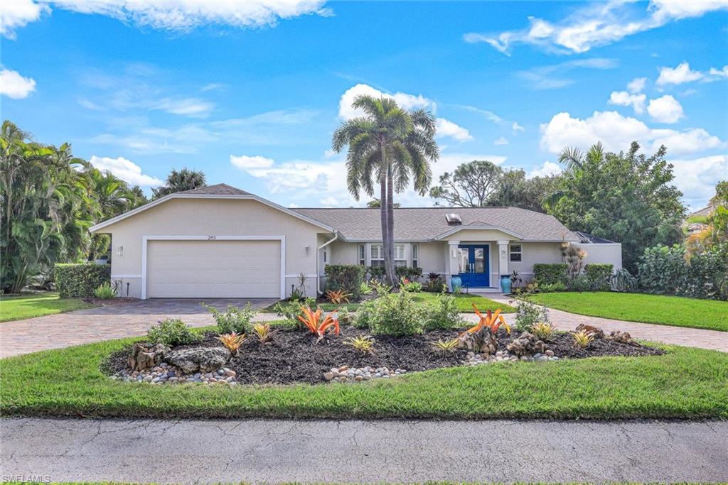 2113 Imperial Golf Course Boulevard Naples, FL 34110 - Photo 42 of 42 a front view of a house with a garden