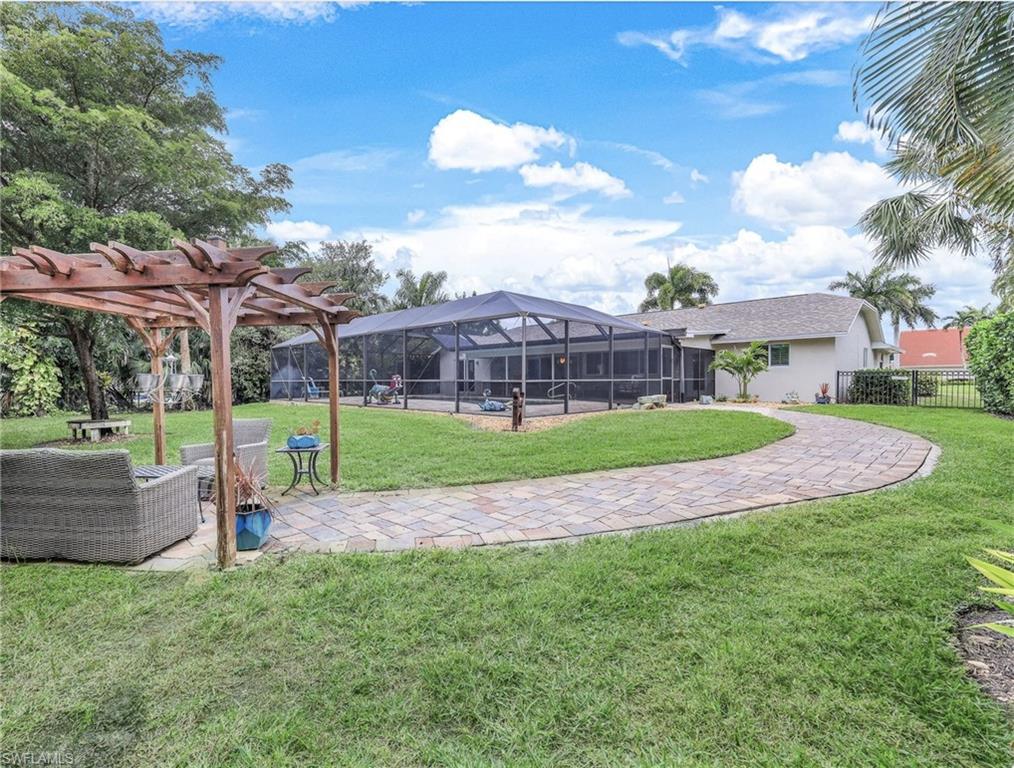 2113 Imperial Golf Course Boulevard Naples, FL 34110 - Photo 6 of 42 a view of a house with a backyard