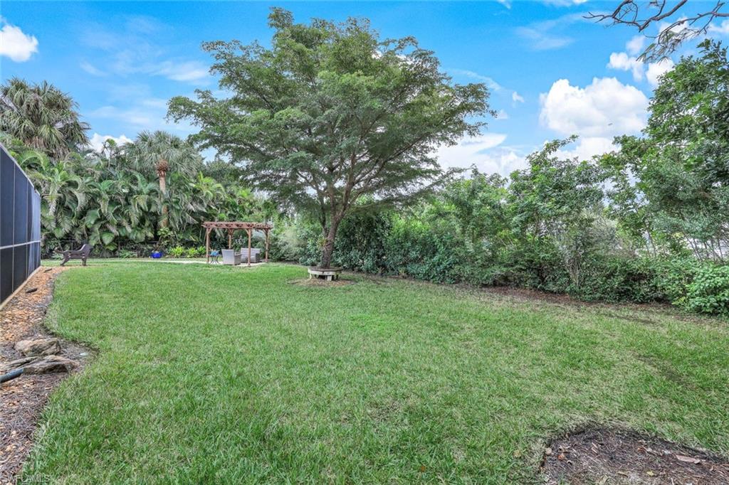2113 Imperial Golf Course Boulevard Naples, FL 34110 - Photo 7 of 42 a view of a field with trees in the background