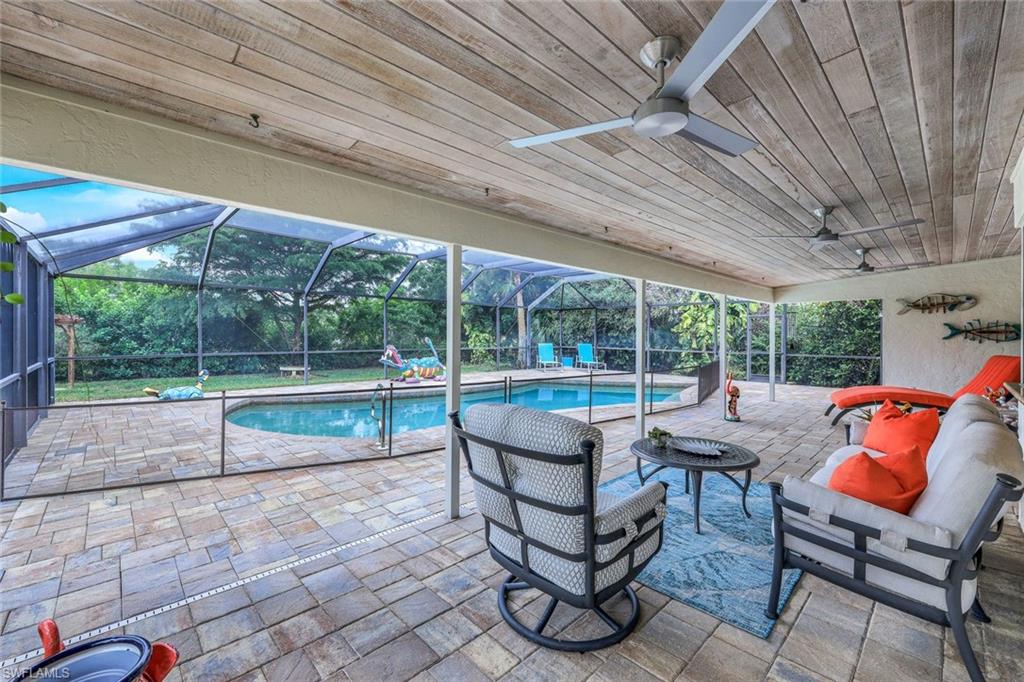 2113 Imperial Golf Course Boulevard Naples, FL 34110 - Photo 8 of 42 a view of chairs and tables in the patio