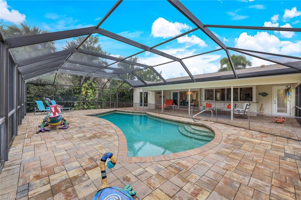 2113 Imperial Golf Course Boulevard Naples, FL 34110 - Photo 9 of 42 a view of a swimming pool with a patio