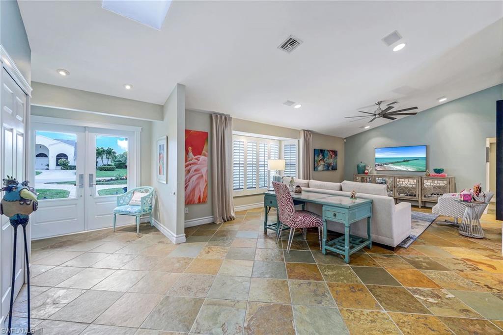 2113 Imperial Golf Course Boulevard Naples, FL 34110 - Photo 10 of 42 a living room with lots of furniture and window