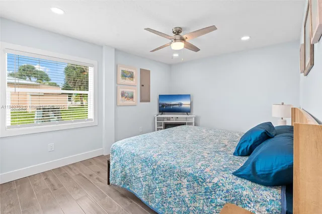 a bedroom with a bed a window and a chandelier