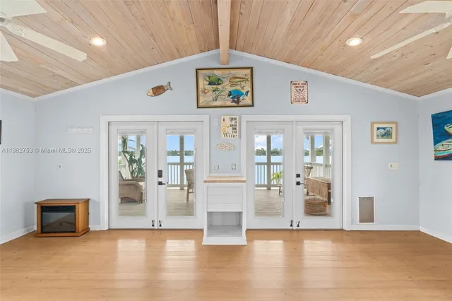 a view of an entryway with wooden floor and a fireplace