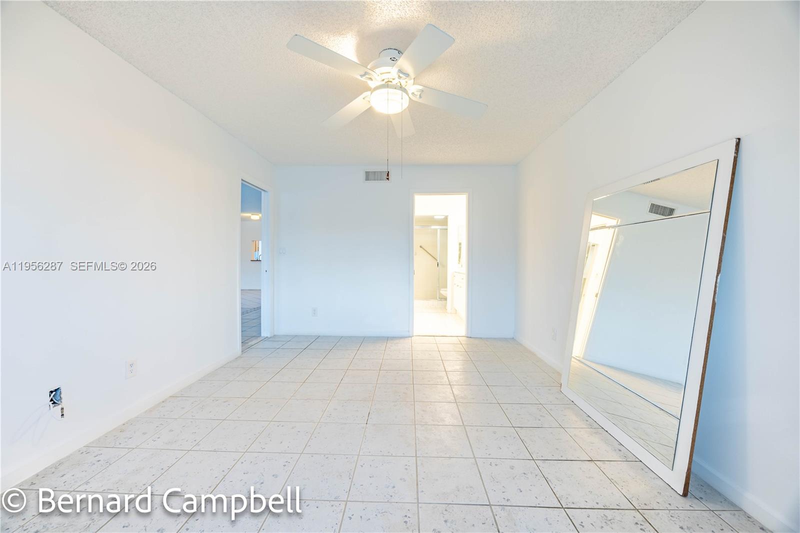 7264 South Devon Drive, Unit 112 Tamarac, FL 33321 - Photo 23 of 45 a view of an empty room and chandelier fan
