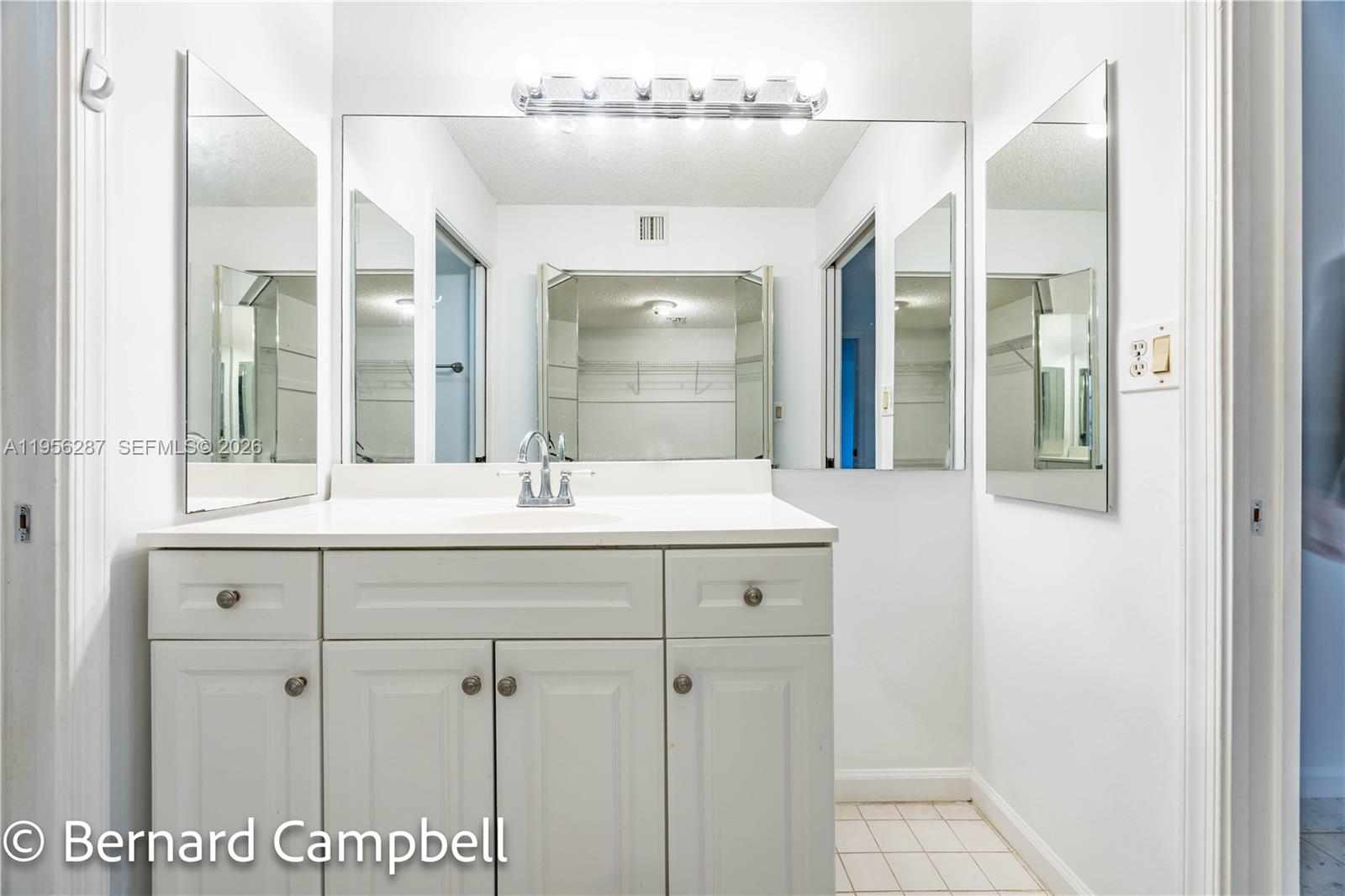 7264 South Devon Drive, Unit 112 Tamarac, FL 33321 - Photo 25 of 45 a bathroom with a sink and a mirror
