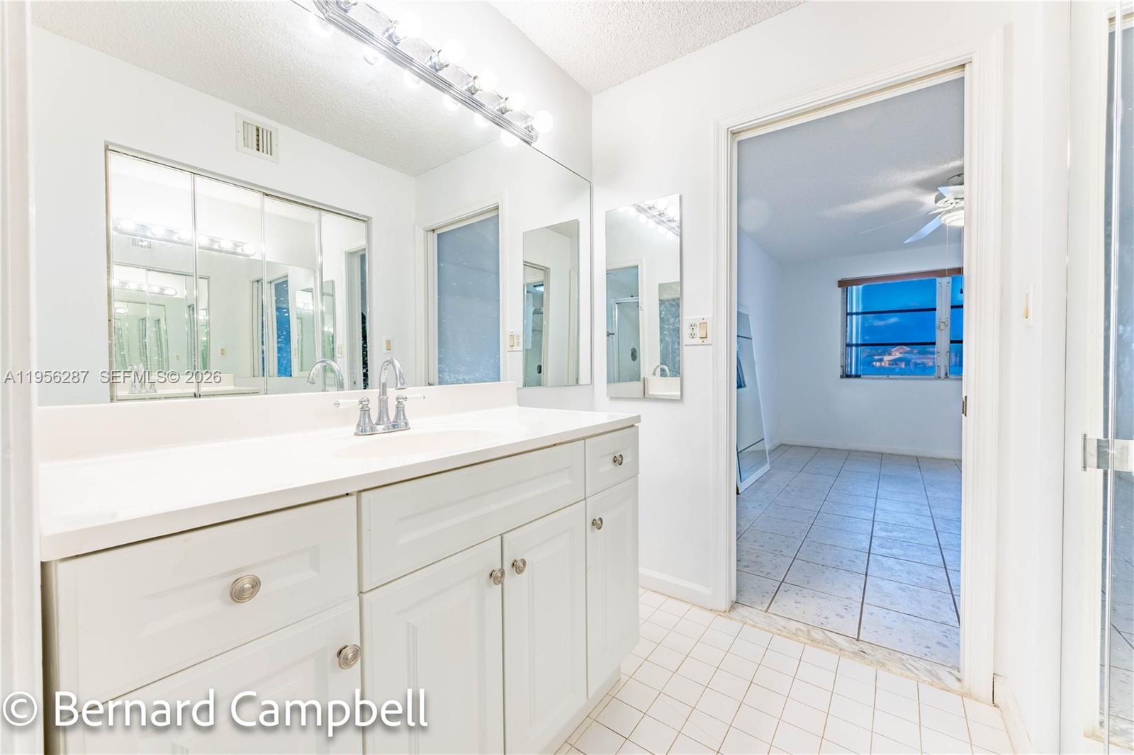 7264 South Devon Drive, Unit 112 Tamarac, FL 33321 - Photo 26 of 45 a bathroom with a sink and a mirror