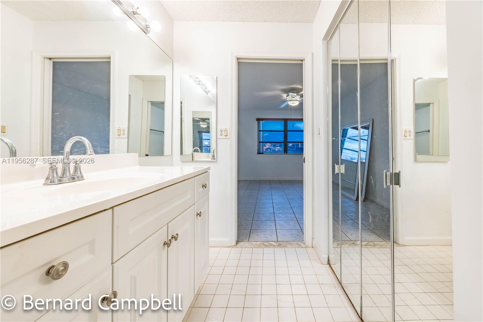 7264 South Devon Drive, Unit 112 Tamarac, FL 33321 - Photo 27 of 45 a bathroom with a sink and a mirror