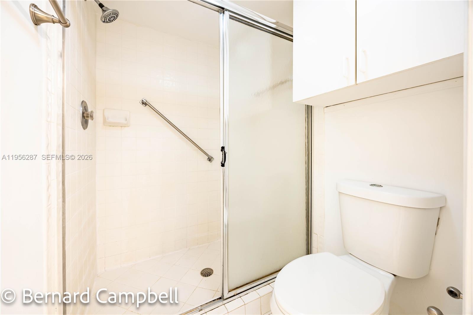7264 South Devon Drive, Unit 112 Tamarac, FL 33321 - Photo 29 of 45 a bathroom with a toilet and a shower
