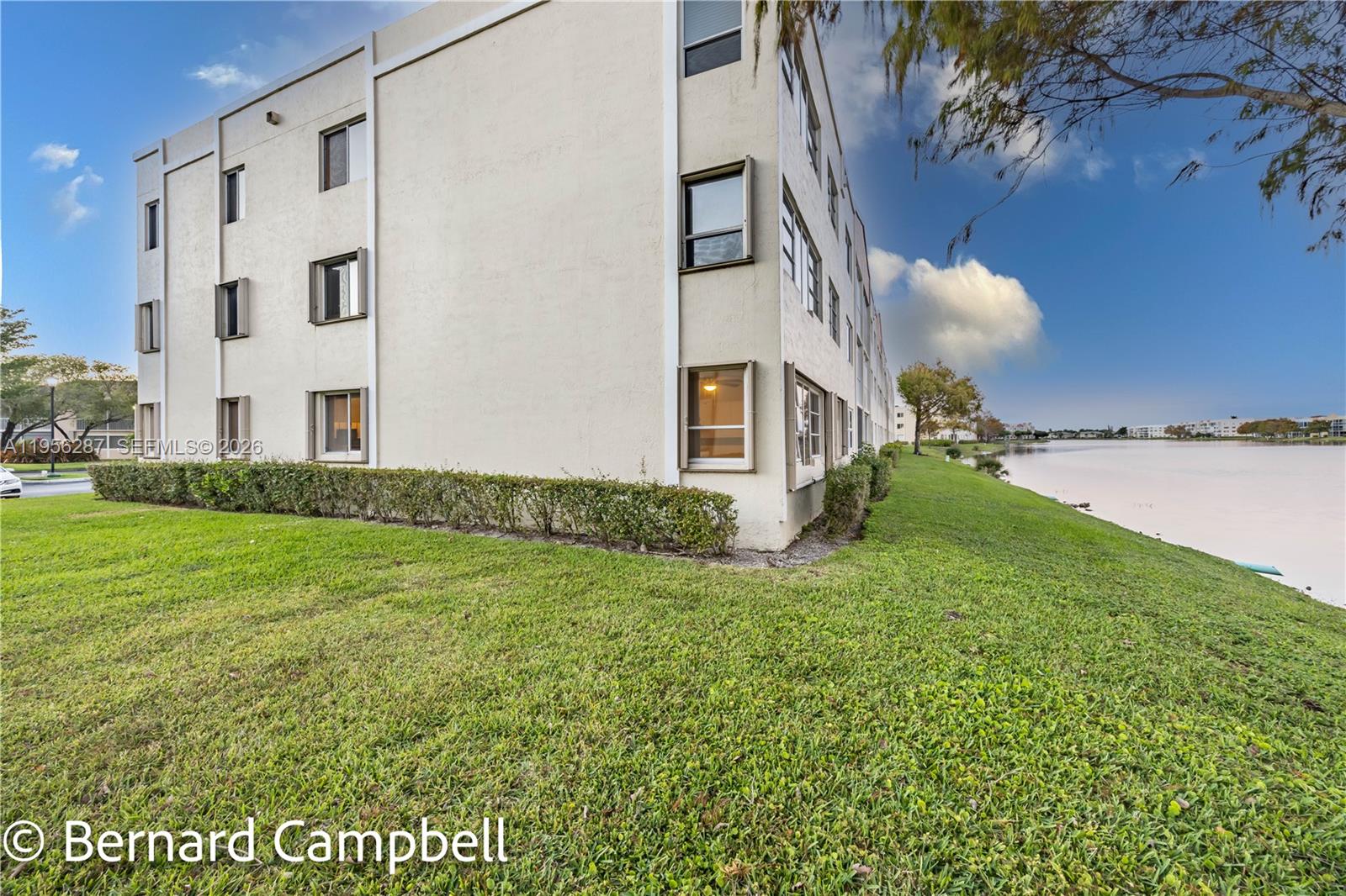 7264 South Devon Drive, Unit 112 Tamarac, FL 33321 - Photo 32 of 45 a view of a big house with a big yard plants and large tree
