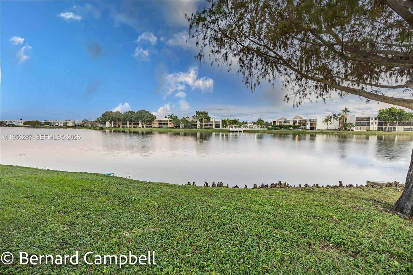 7264 South Devon Drive, Unit 112 Tamarac, FL 33321 - Photo 33 of 45 a view of a lake with houses in the back