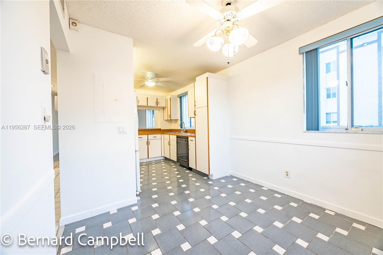 7264 South Devon Drive, Unit 112 Tamarac, FL 33321 - Photo 6 of 45 a view of a kitchen with a refrigerator and a stove top oven