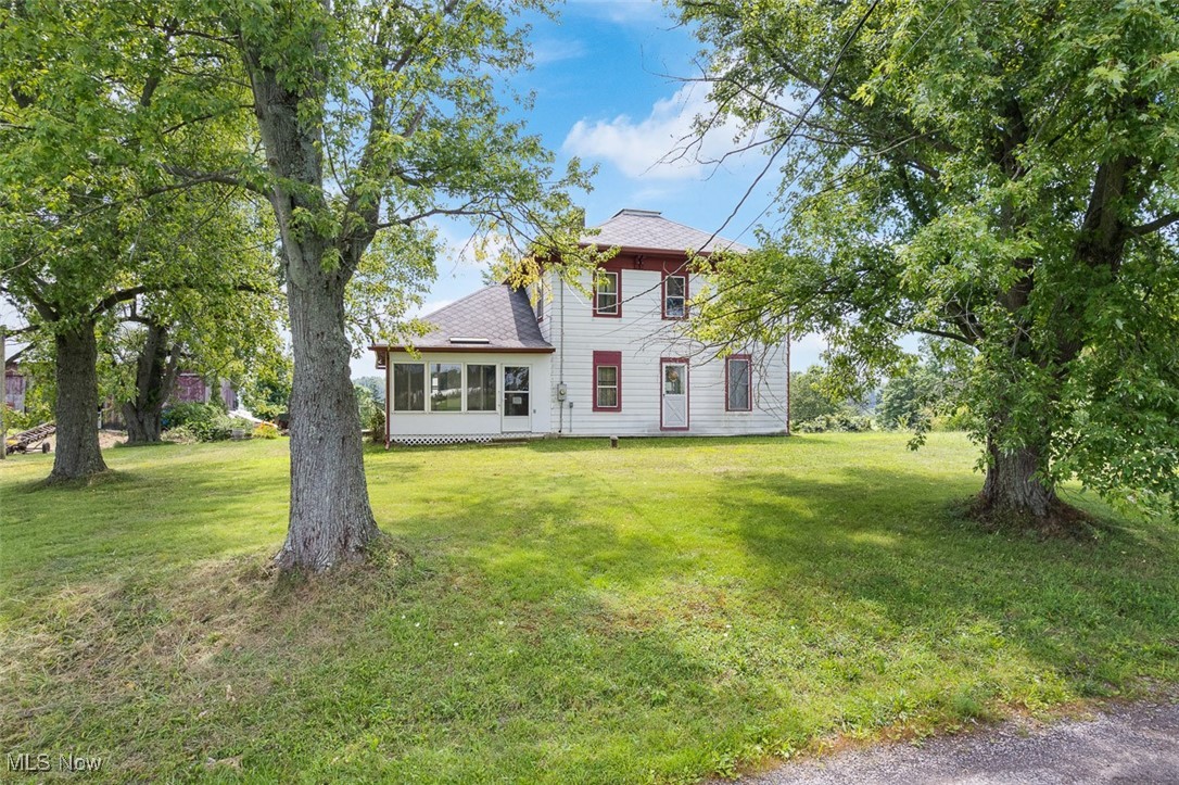 12098 Porr Road Doylestown, OH 44230 - Photo 1 of 34 Front view of house with a lawn and a sunroom