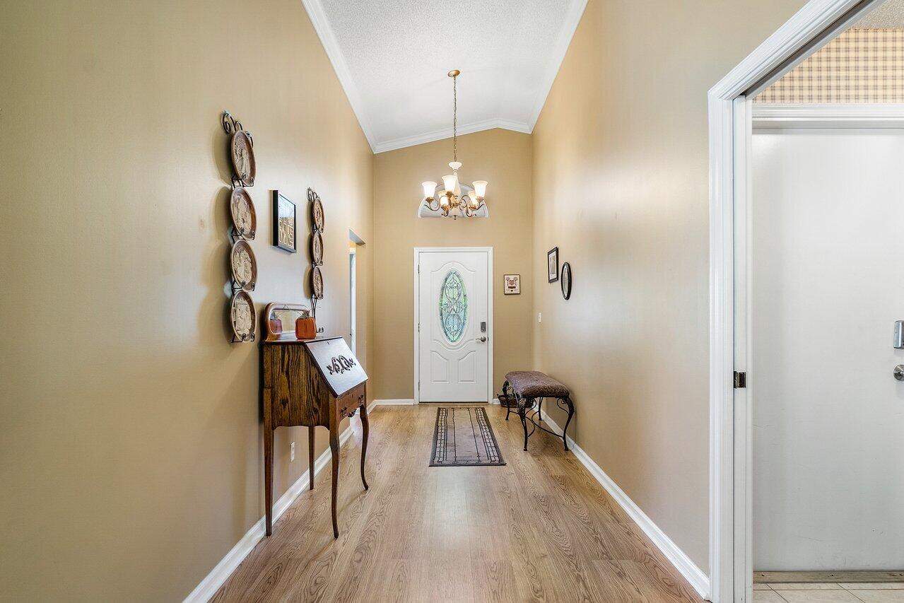 1410 Bethpage Way Greenacres, FL 33413 - Photo 2 of 29 a view of a hallway with furniture and wooden floor