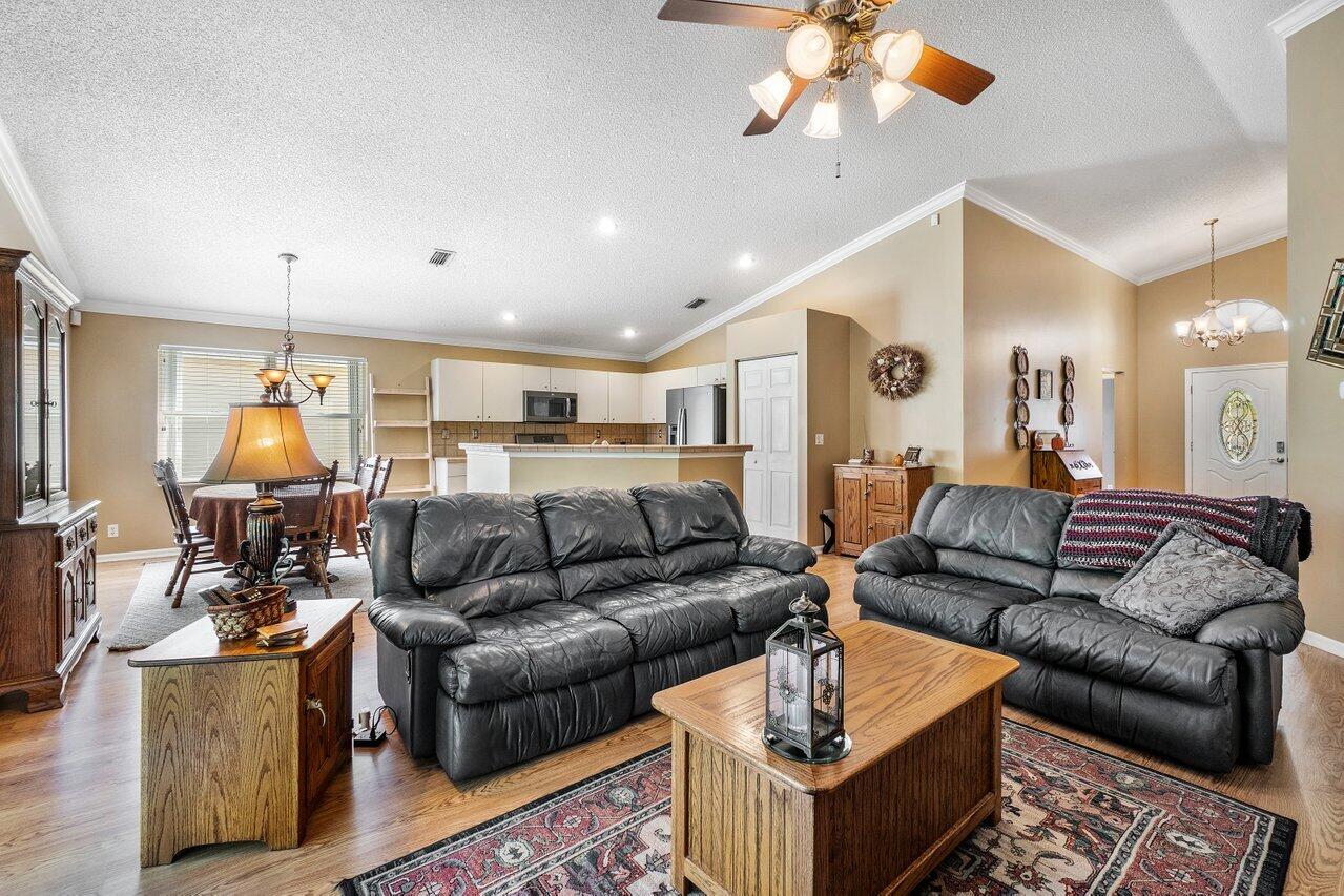 1410 Bethpage Way Greenacres, FL 33413 - Photo 12 of 29 a living room with furniture and a chandelier