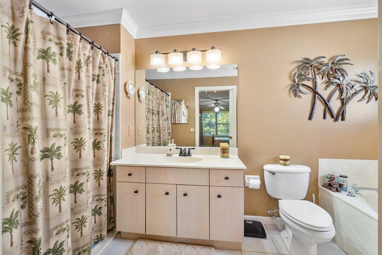 1410 Bethpage Way Greenacres, FL 33413 - Photo 13 of 29 a bathroom with a granite countertop sink a toilet and a mirror
