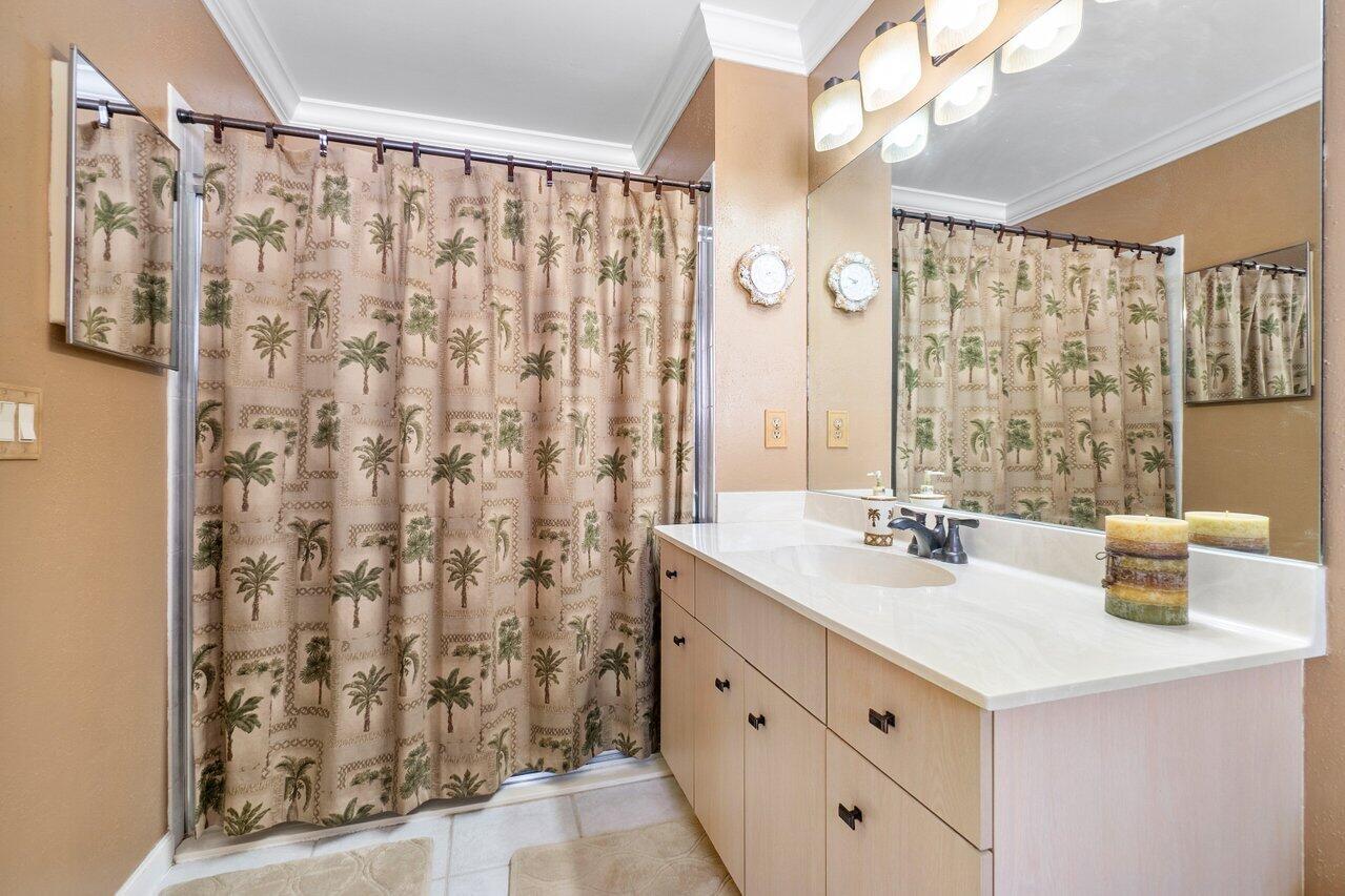 1410 Bethpage Way Greenacres, FL 33413 - Photo 15 of 29 a bathroom with a sink and a mirror