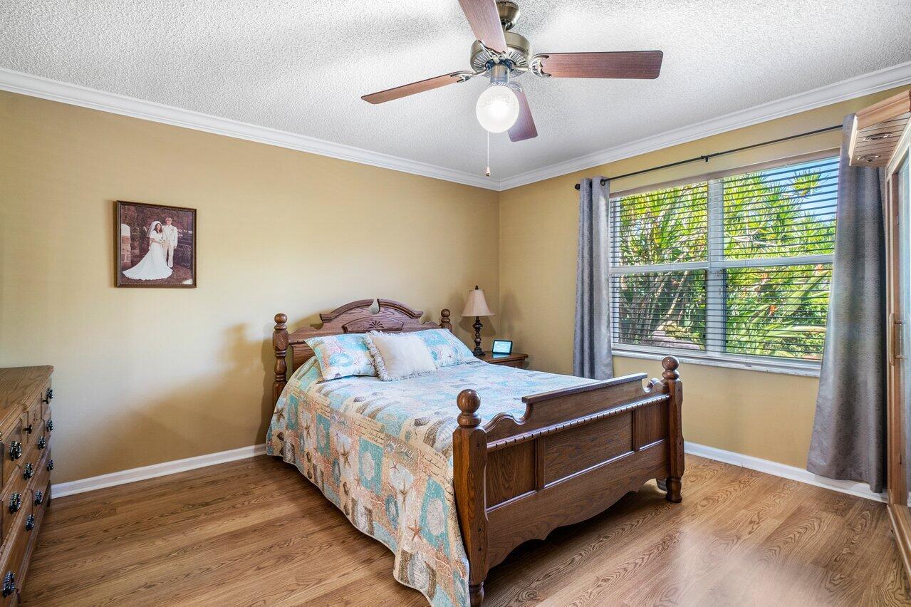 1410 Bethpage Way Greenacres, FL 33413 - Photo 16 of 29 a bed sitting in a bedroom next to a window