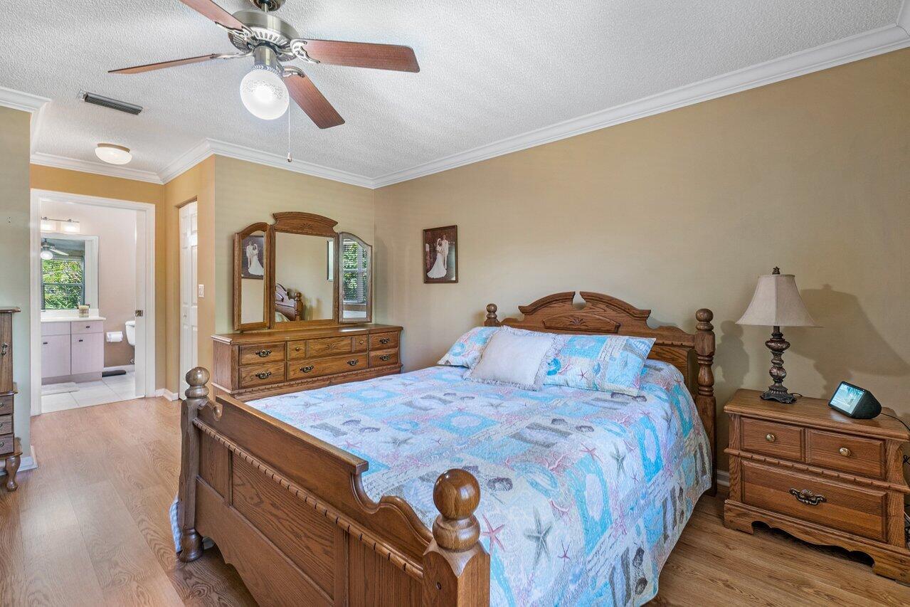 1410 Bethpage Way Greenacres, FL 33413 - Photo 17 of 29 a bedroom with a bed and wooden floor