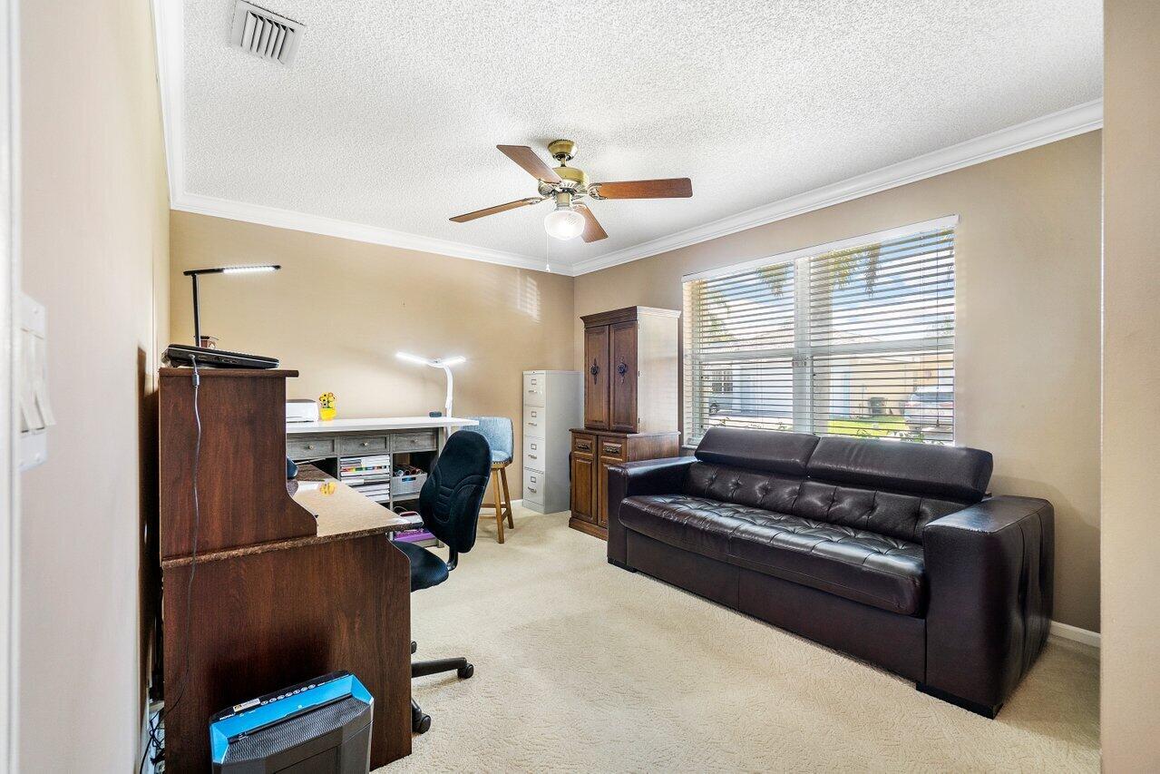 1410 Bethpage Way Greenacres, FL 33413 - Photo 18 of 29 a living room with furniture ceiling fan and a window